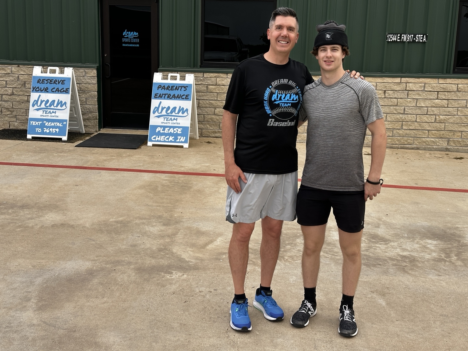 Patrick with Coach Miken outside the DREAM Team Sports Center
