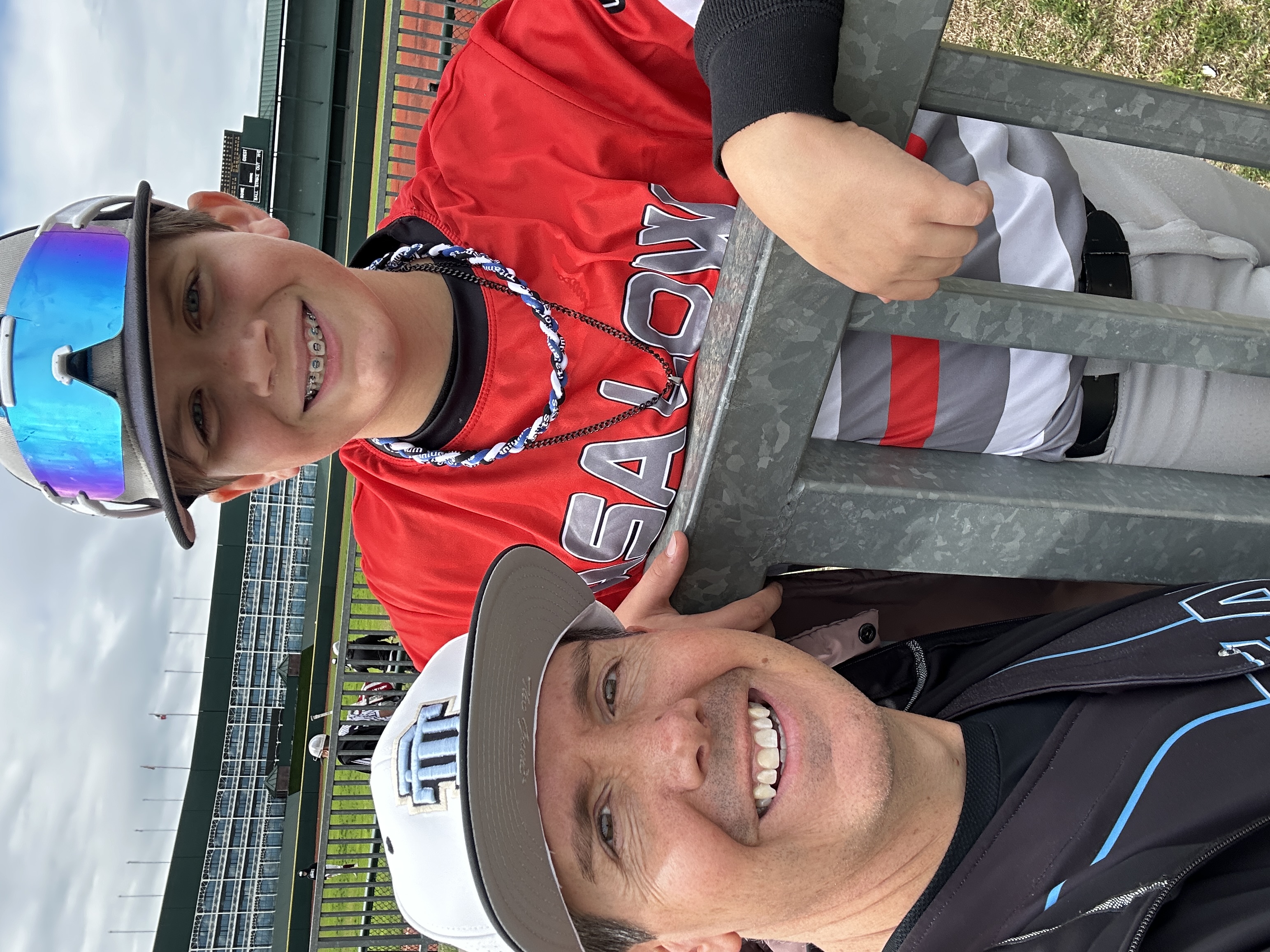 Patrick with a young baseball player at a youth baseball event